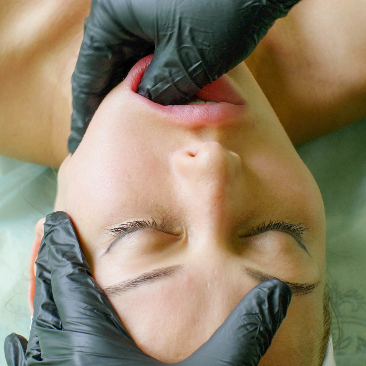 Intra-oral TMJ massage performed with gloved hands