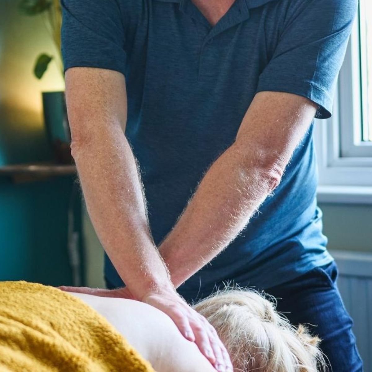 A myofascial release hold - cross handed at head of the table.